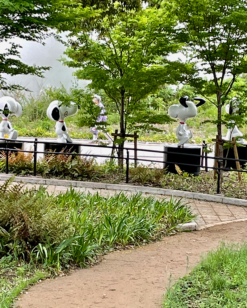 木々の間にスヌーピーが姿を現す写真