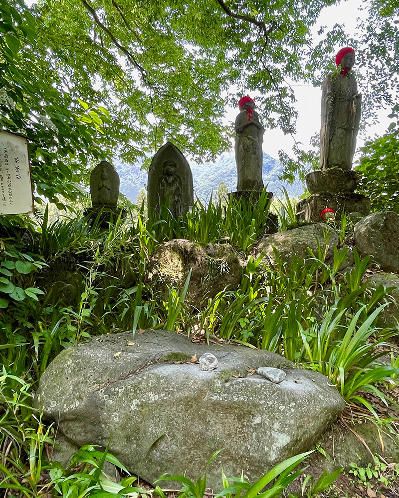 お地蔵さんの前の茶釜石は叩くと金属の音がする写真